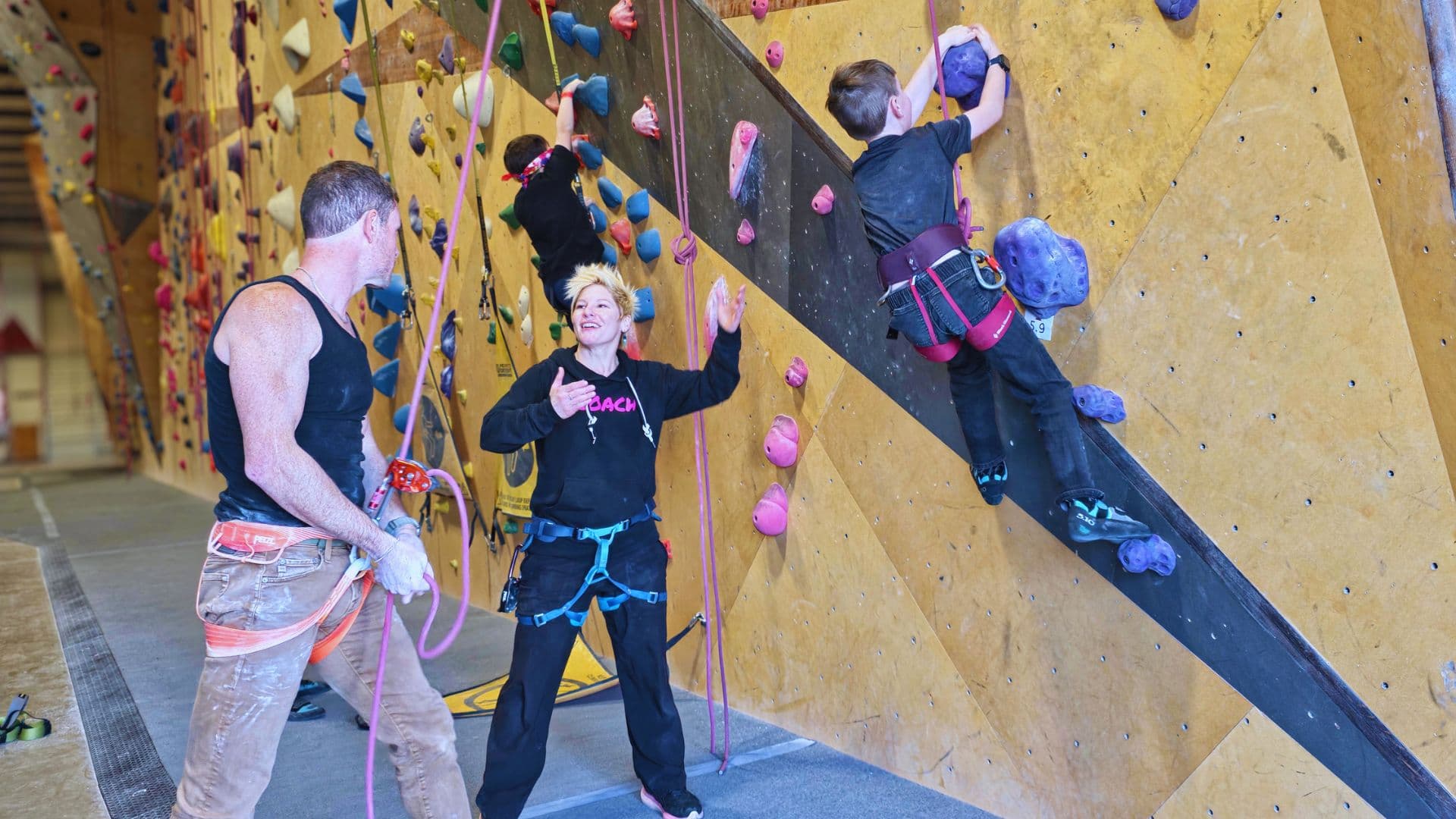 Coach and family talking at the climbing gym